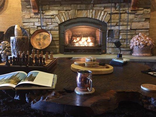 View from the couch, looking at picturesque fireplace.