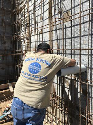 Our guy securing conduit to rebar