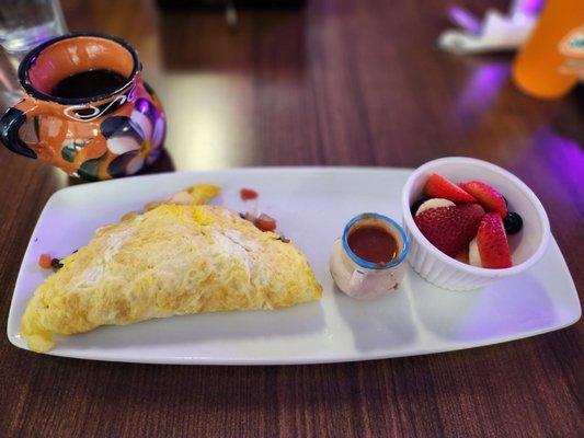 Omelet  with tomatoes, onions, jalapeños and mushrooms  and side of seasonal fruit and salsa roja