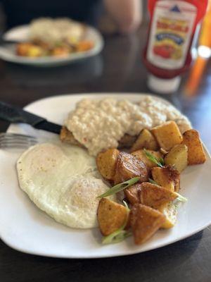 Chicken fried steak with eggs and country potatoes