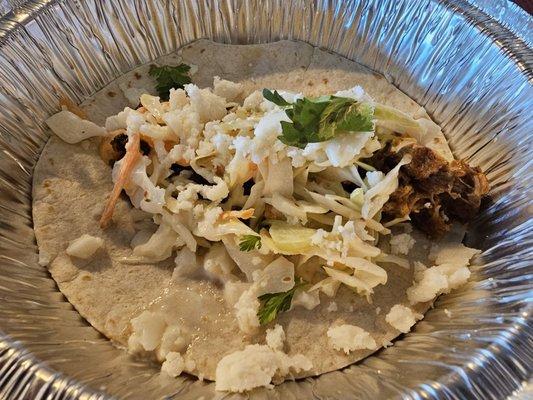 Pork taco: bbq pork, queso fresco, crema, & cilantro. So good!