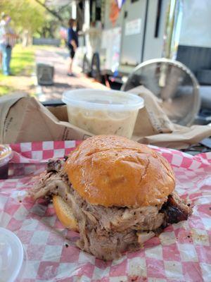 Sliced brisket sandwich on brioche and pint of Smoked Mac