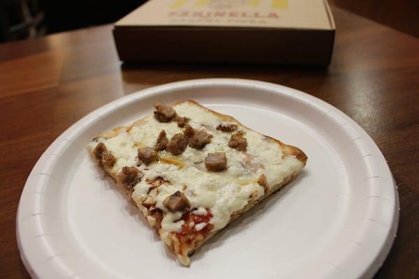 Half of a $7.10 slice (the Boscaiola with sausage, mushroom, mozz and smoked provolone).