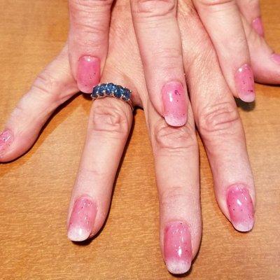 Sheer red nails with white tips.