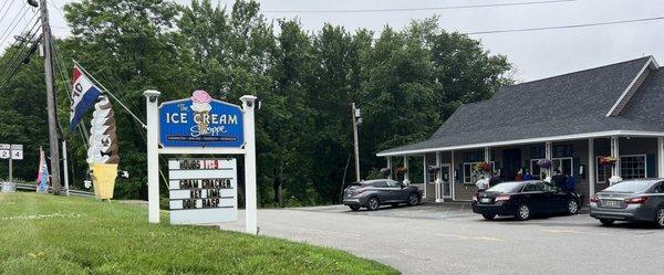 Exterior shot with hours on the sign. AMPLE seating on the wrap-around porch in the back!