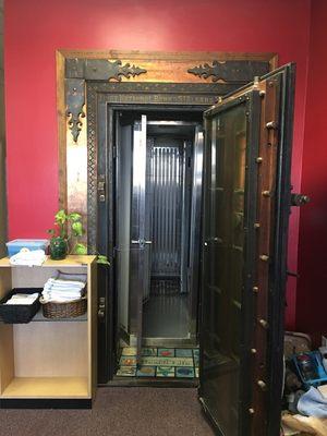 Stand up tanning booth inside of an antique bank vault