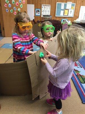 Dramatic play activities change throughout the school year. Here we are builders.