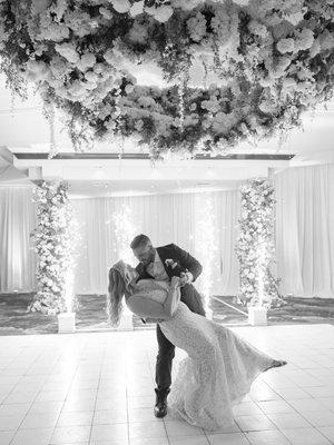 First dance at reception with custom floral chandelier over dance floor.