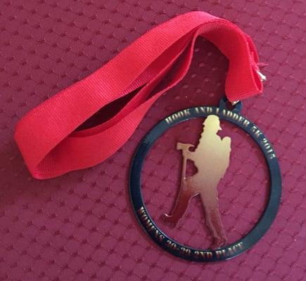 second place age group finisher's medal with cut out of a fireman