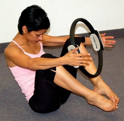 Using the Magic Circle during a Mat Pilates class.