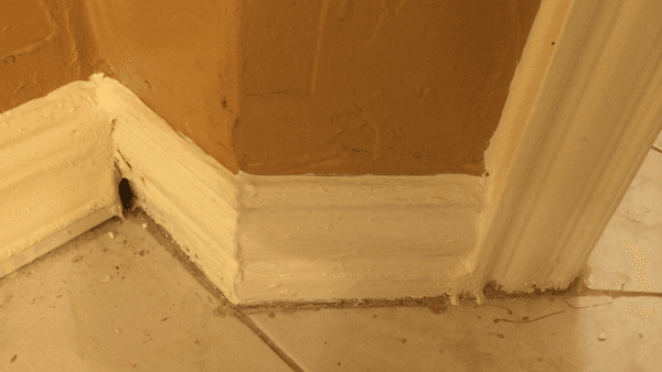 This is what my baseboards look like after GMZ finished painting them. They were paid to sand, putty, caulk, and paint.