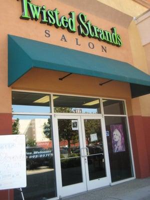 Twisted Strands Hair Studio located in front of Tinsletown