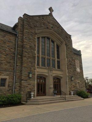 Main entrance showing the exterior of The Narthex and stained glass windows of the choir loft