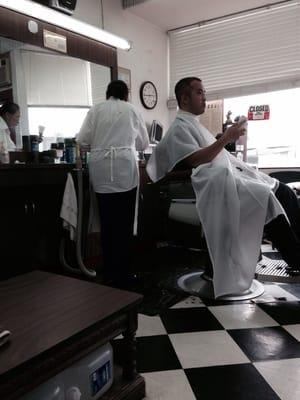 This guy was texting while getting his hair cut