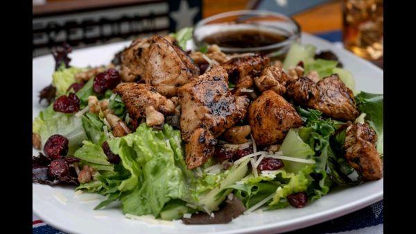 Grilled Chicken, dried cranberries, chopped pecans, cherry tomatoes and shredded parmesan top a bed of mixed greens.