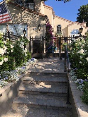 Perimeter front fence with integrated mail/package drop box and ornamental iron pedestrian gate.