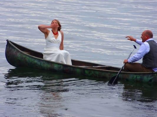 A bride blows a kiss as her husband rows them "off into the sunset" after a boathouse wedding brunch