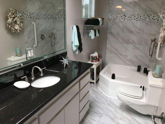 New Counter top, sink, shower tile, and floor.   Reglazed toilet and tub.