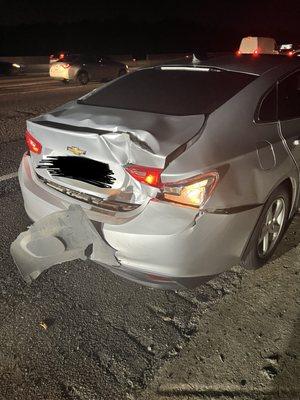 Silver Chevrolet Malibu with rear end damage