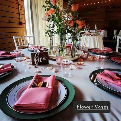 Sage green chargers with multiple floral vases fot the centerpieces.