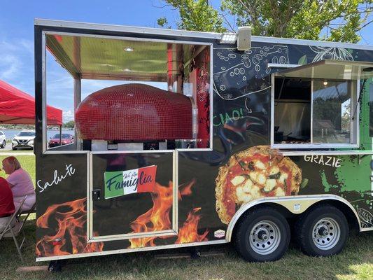 QZO red pizza oven at rear of food truck