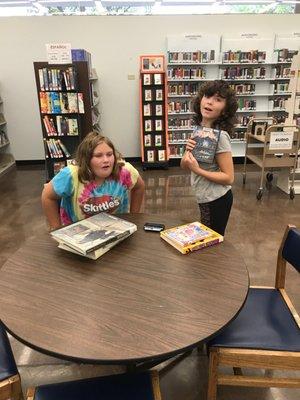 Timothy took the class on Code. Girls are getting books to check out