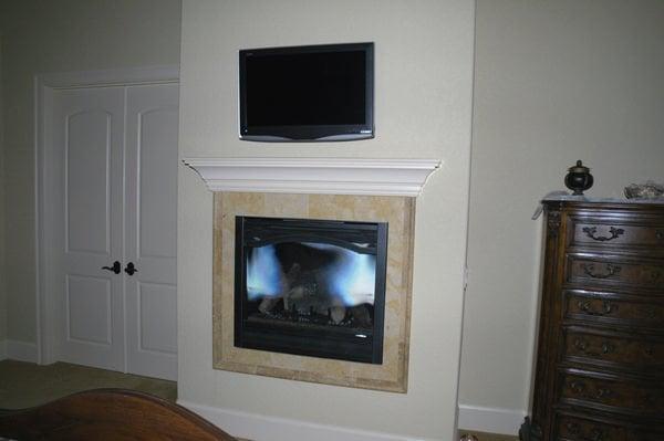 Televison OVER fireplace.