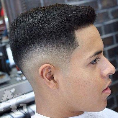 Clean fade with hair on top.