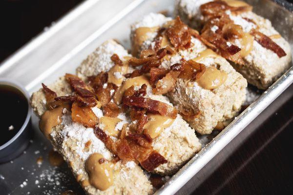 Funky Kong French Toast Stix... Deep fried banana bread with peanut butter drizzle, apple wood smoked bacon and powdered sugar