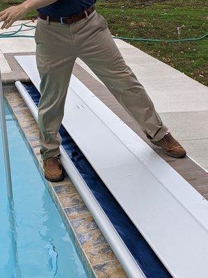 This is how we have to stand to clean the deep end of the pool because we can't stand on the lid and the cover is not supposed to go flush.