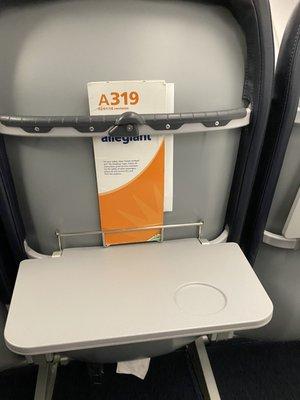 You have the tray table but no room to store your headphones or glasses and reading materials