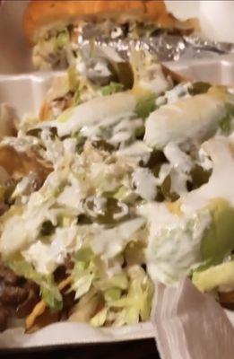 Loaded carne asada nachos, half of a carne asada torta