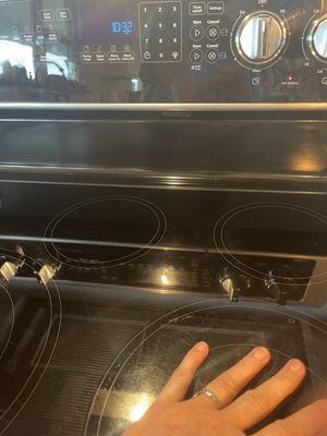 We were able to completely rest our hands on the stove top. Mind you he was here to replace our MICROWAVE