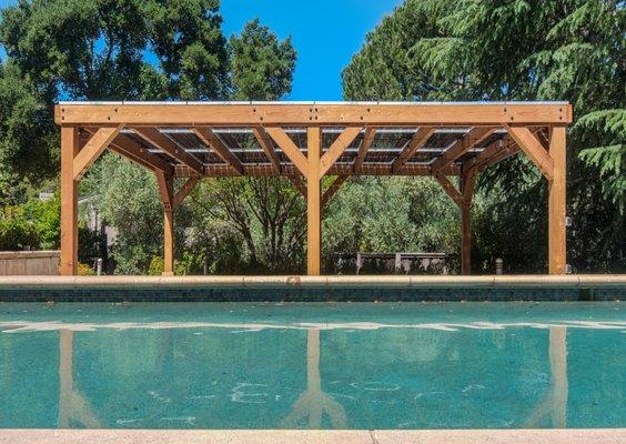 Solar pergola installation by a pool with contemporary design.