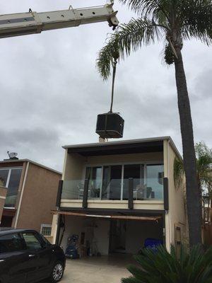 Crane lift to place equipment on a roof top