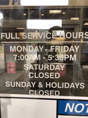 Store front hours posted on front door