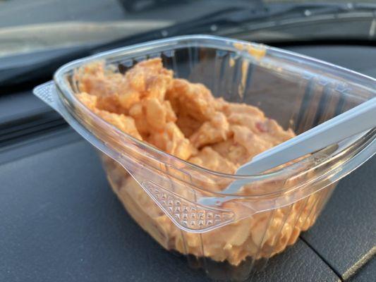 container of pimento cheese securely staged on my vehicle's dashboard