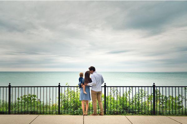 Family looking at lake kissing each other