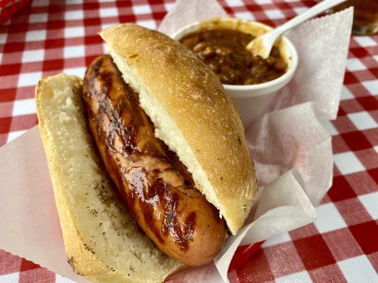 Handcrafted Frankfurter on fresh baked roll with house made baked beans.