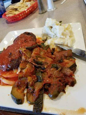 Bisteck a la mexicana, the steak is not authentic with canned tomato and overcooked veggies. Flavorless potatoes on the side.