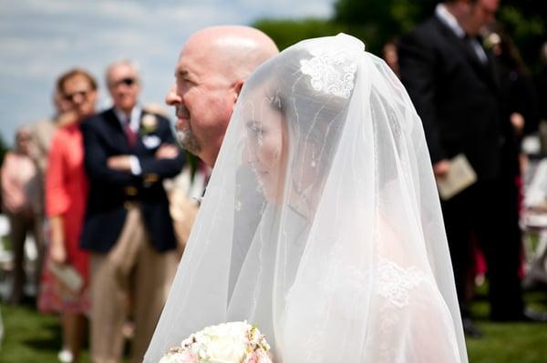 A moment from Elizabeth & Ben's 2013 wedding captured by Mary Cyrus. Elizabeth's father escorts her up the aisle to her groom.