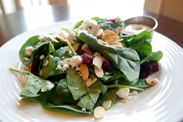 Pickled Beets Salad with spinach, topped with goat cheese, toasted almonds and apple cider vinaigrette