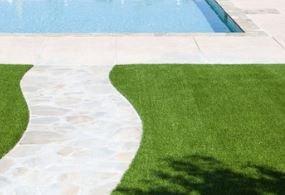 synthetic grass with stamped concrete walkway