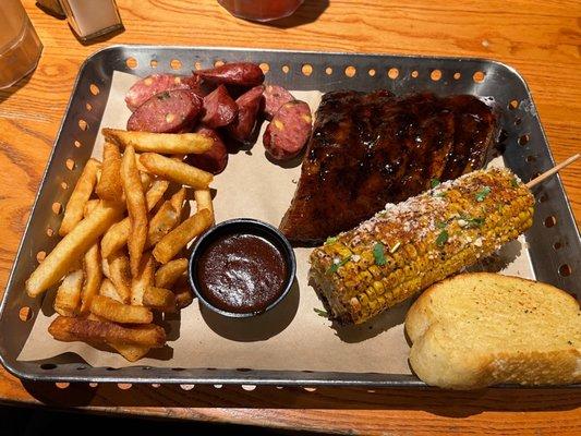 Smokehouse Combo with 1/2 rack ribs, jalapeño cheese sausage, fries and Mexican street corn.