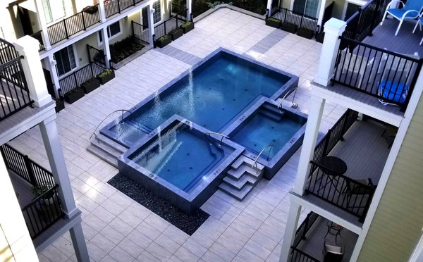 Magnificent Vanishing Edge pool located in the center of  courtyard and above the parking lot of Luxury Apartments in Morristown, NJ