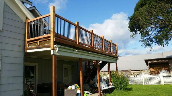 Rebuild of a rotten deck all new Redwood and metal galvanized pipes for pickets