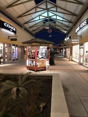 Our kiosk is located in front of Michael Kors and Coach Men in the Houston Premium Outlets.