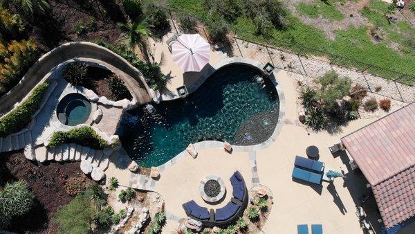 Full backyard dreamscape transformation with pool, spa, waterslide, grotto, outdoor living space and much more!