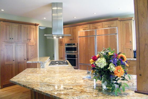 Cherry cabinetry with custom built refrigerator panels.