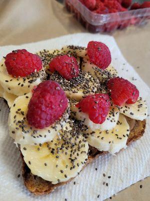 Ezekiel Cinnamon Toast topped with almond butter, organic fresh fruit and chia seeds.